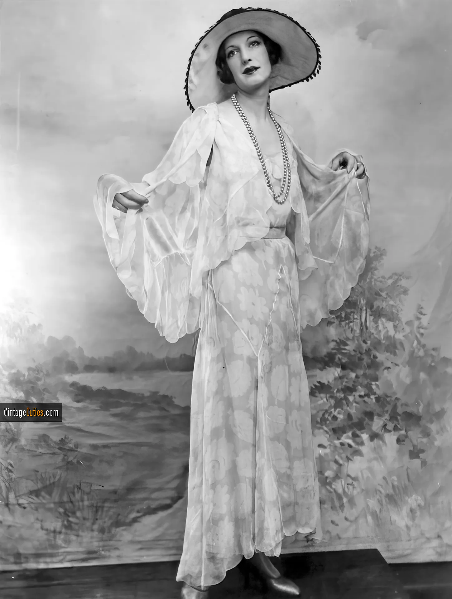 Gorgeous beauty poses in her white vintage dress and a hat
