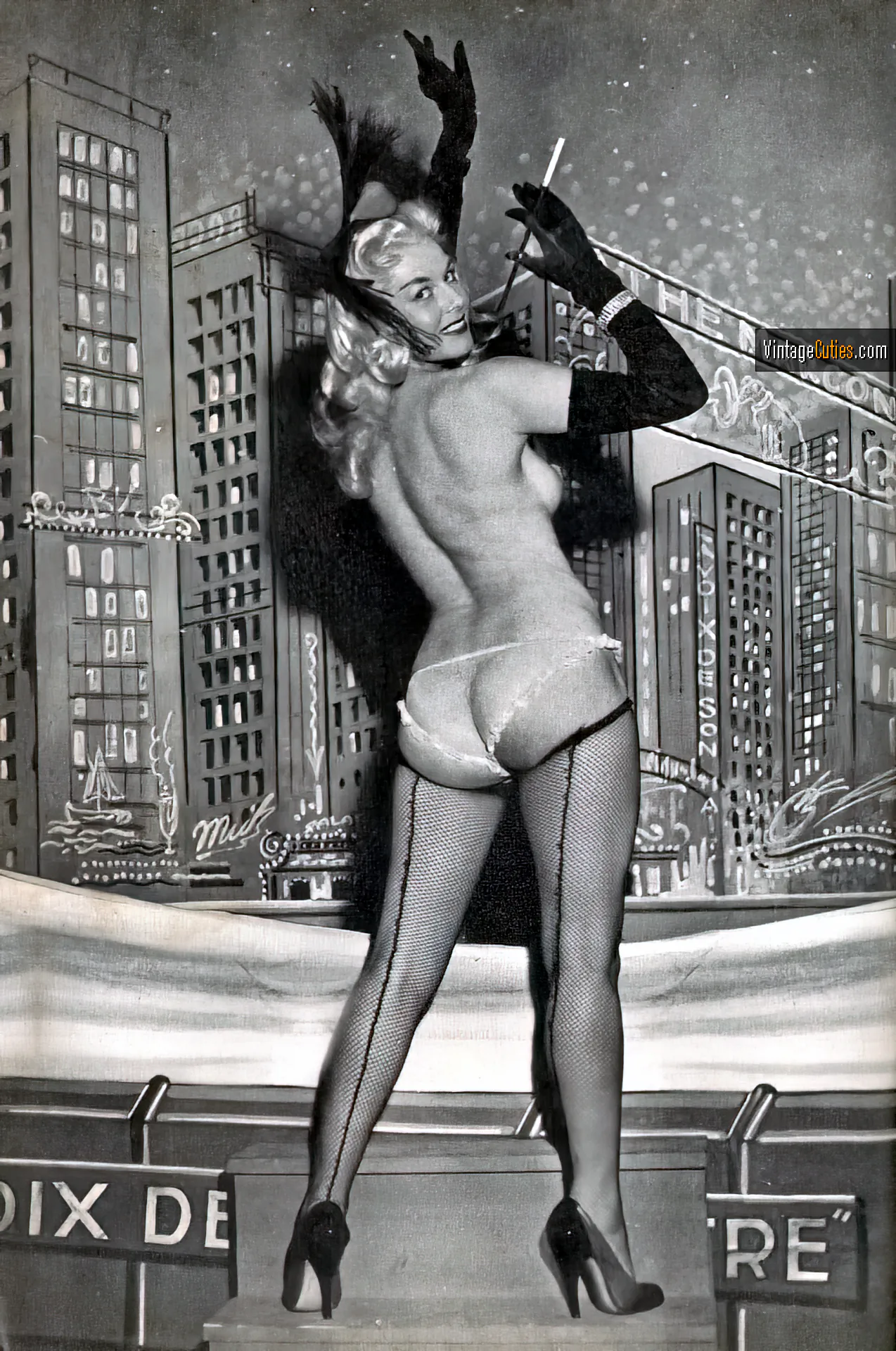 Burlesque blonde holds a long cigarette shows her juicy ass