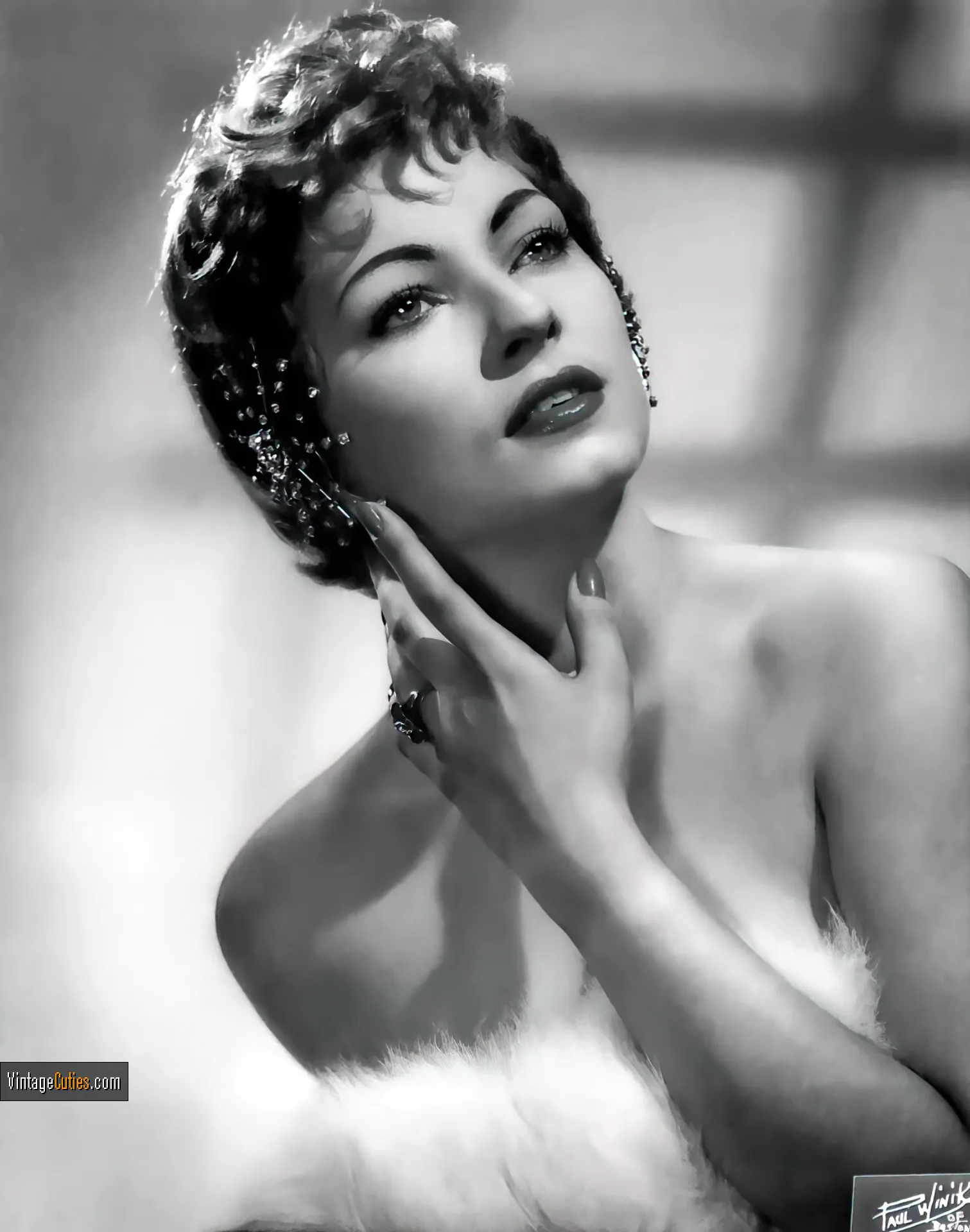 Graceful burlesque lady with gorgeous eyes wears makeup