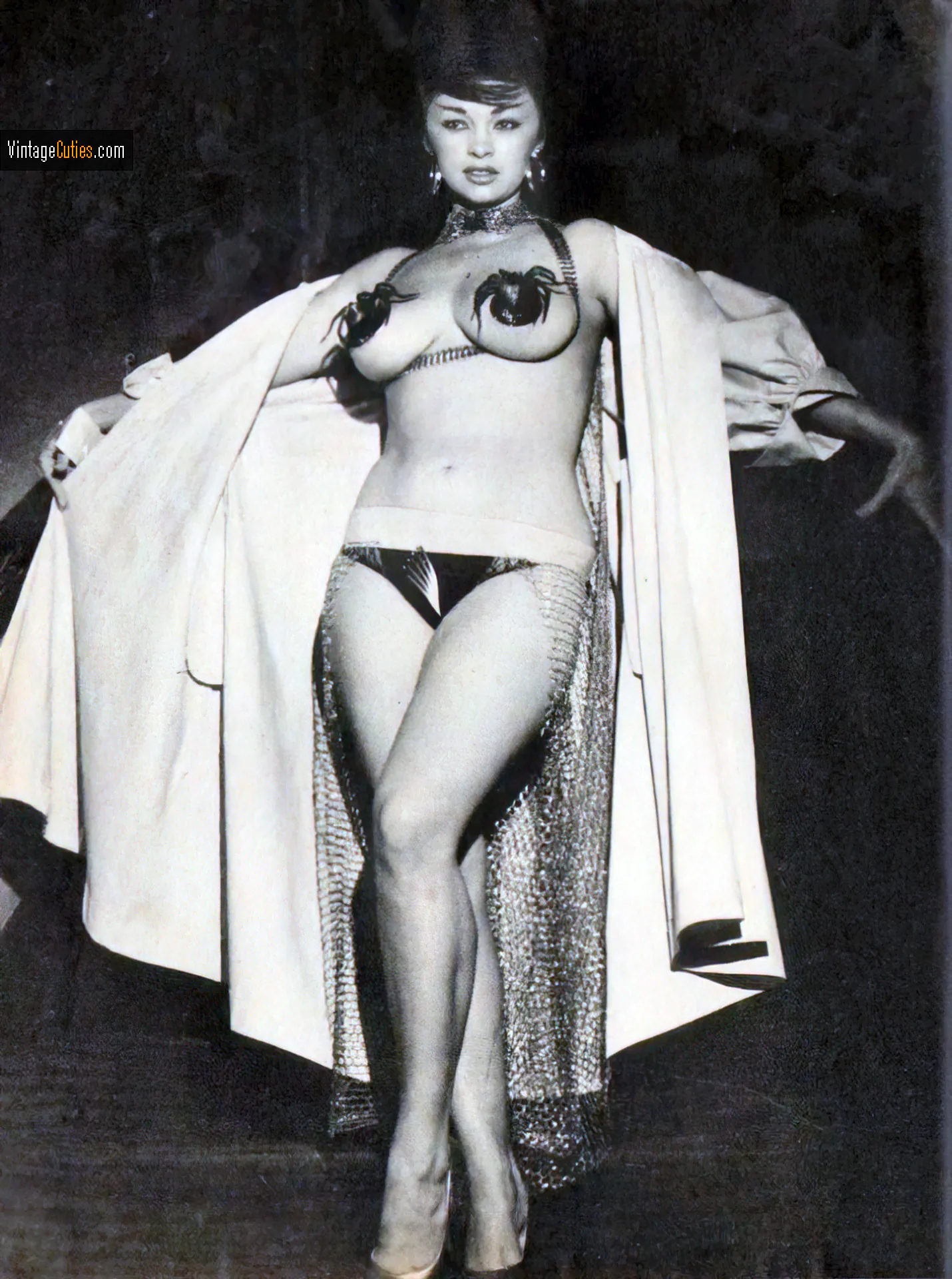 Busty burlesque babe in a robe has her nipples covered