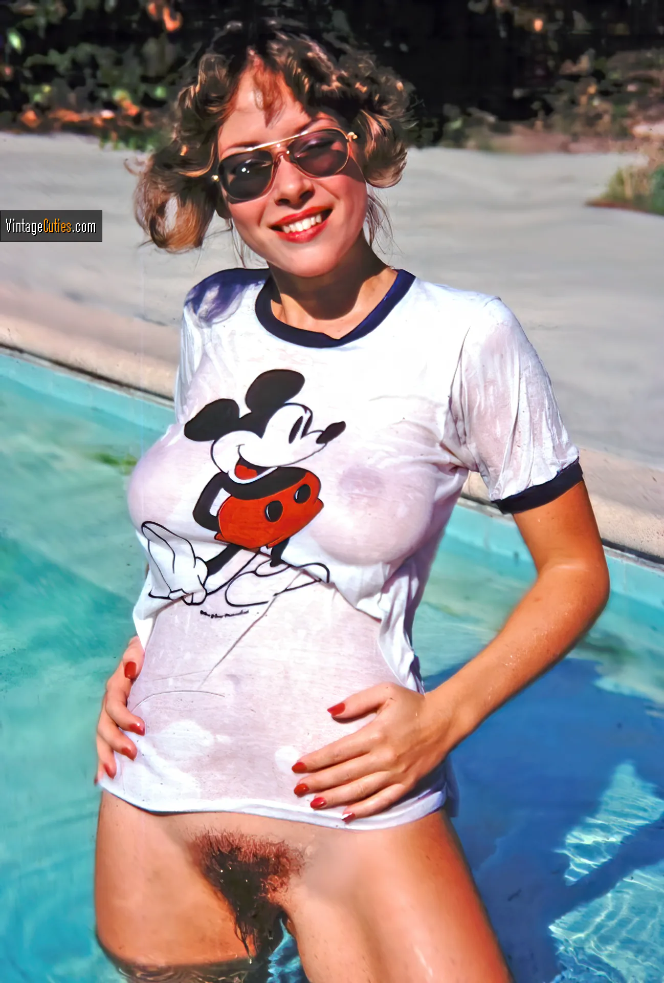 Classic woman wears a wet shirt dips her hairy pussy into the pool