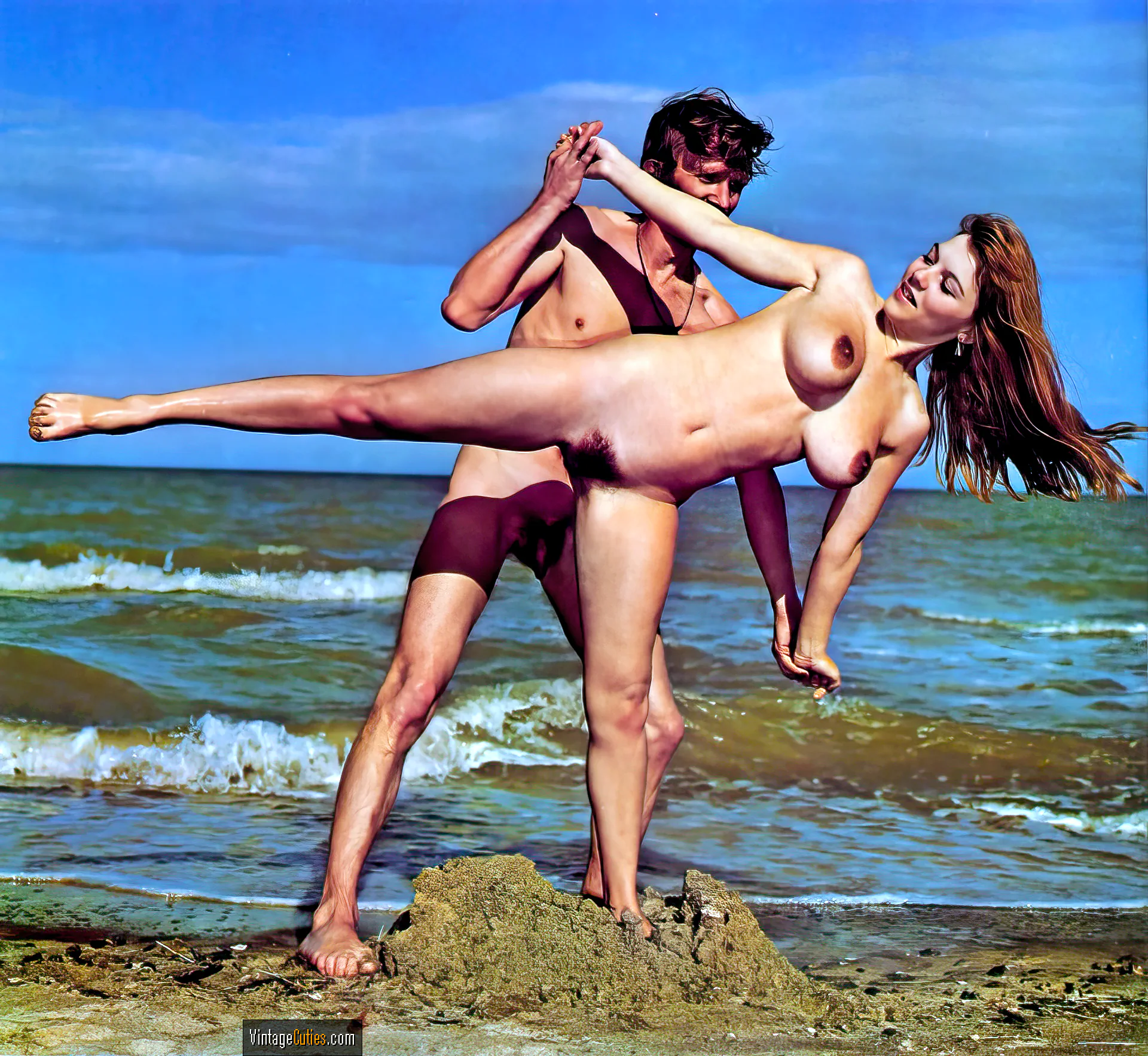 Michelle Angelo and a guy posing naked on the beach