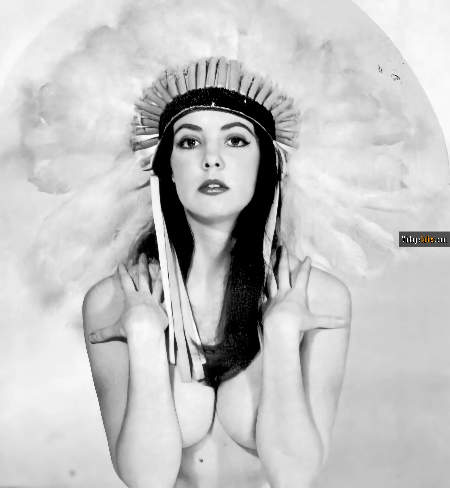 Colette Berne covers her tits wearing an extravagant hat