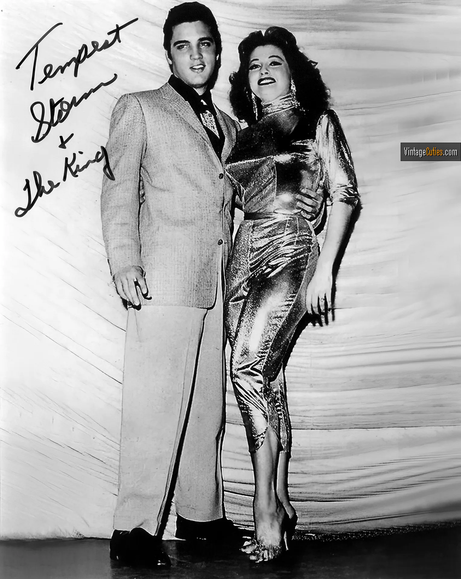Tempest Storm posing with a celebrity in a tight suit